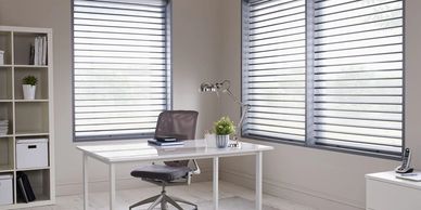 Sheer shades in windows of a corner office.  Commercial window treatments in Omaha & beyond