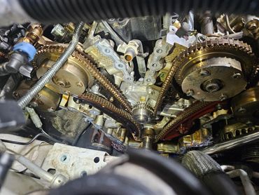 Close-up of a car engine's timing chain and gears.