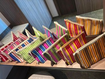 Colorful striped fabric pouches arranged neatly on a wooden surface.