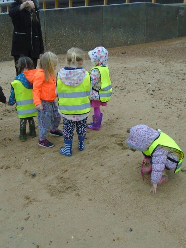 A group of kids playing in sand