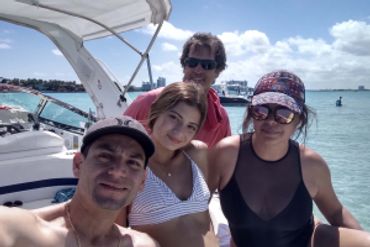 family gather on a weekend to enjoy a day sandbar water in a private Miami Beach boat tour
