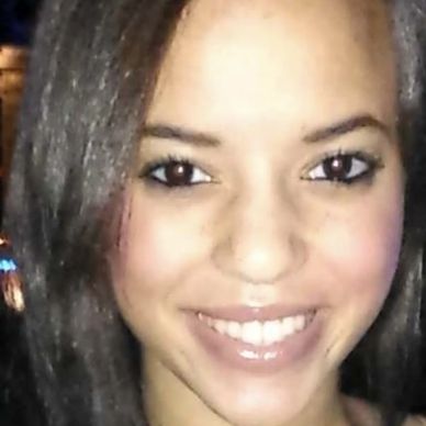 Smiling young woman with straight hair.
