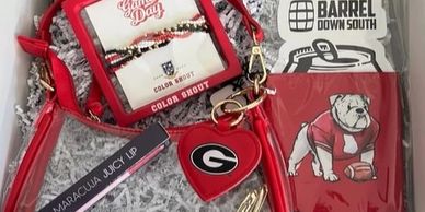 Gift box with red purse, lip gloss, and bulldog koozie.
