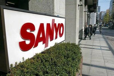 Large SANYO sign outside a corporate building on a sunny day.