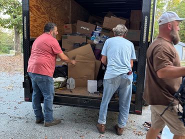 Dewayne and two volunteers loading a trailer to take to North Carolina