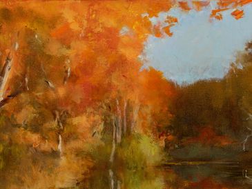 A serene autumn landscape with vibrant orange trees and a calm river.