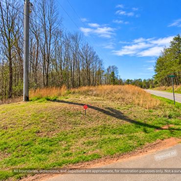 Corner of paved NC Highway 10 and Hywood Rd at wooded land for sale near Casar NC