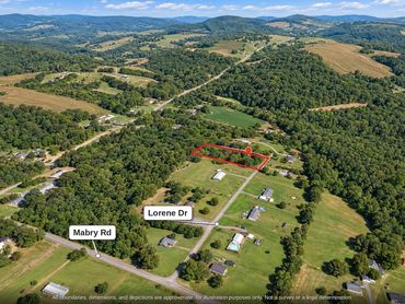 Aerial view of the wooded 1 acre land near Albemarle NC, looking north up Lorene Dr from Mabry Rd