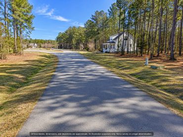 Paved private street with homes in Arlington Place, a gated community near Oriental NC