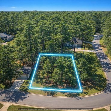 Aerial of the wooded 0.39 acre lot along paved Mill Creek Dr (outline approximate)