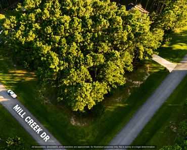 Aerial of the wooded lot along Mill Creek Dr in Arlington Place, Minnesott Beach NC