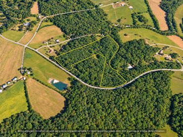 Aerial of 20.65 acre parcel near Chapel Hill NC with nearby farms and homes, outline approximate