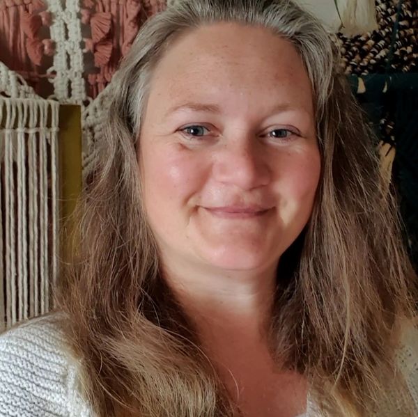 A headshot of Karen, the boss and creator, looking ahead and smiling