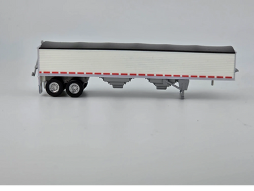 Scale model of a white semi-trailer with black roof and red details.