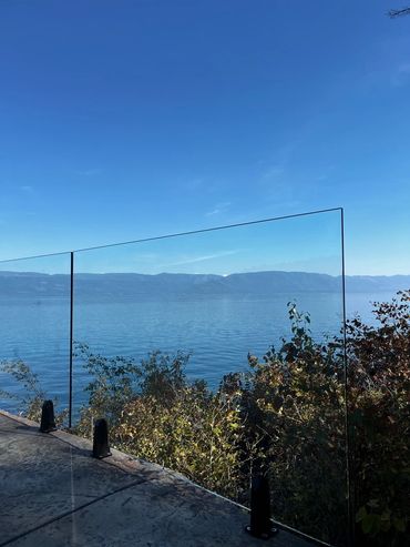 Custom glass railing in Lakeside installed by Precision Glass for a builder.