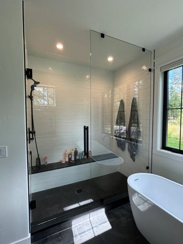 Custom glass shower enclosure installed by Precision Glass in a Whitefish home for a homeowner