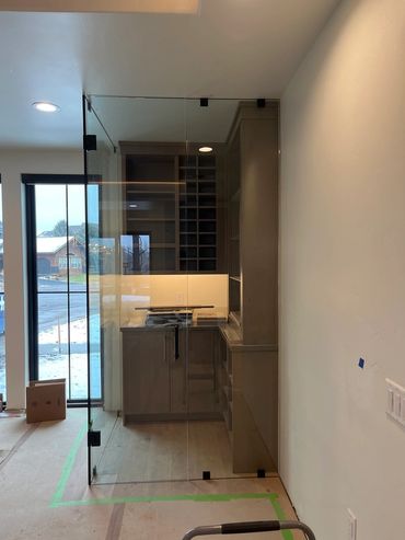 Custom glass wine room in a Kalispell remodel project for a builder that Precision Glass helped