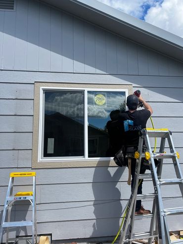 Brett, Precision Glass' lead glazier, installing trim on a Columbia Falls window replacement project
