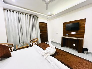 Cozy hotel room with a neatly made bed and towel swan.