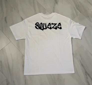 White T-shirt with black graffiti-style text 'SQUEZE' on the back.