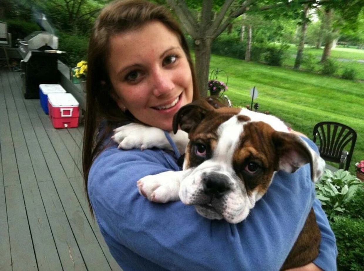 Dog being held by smiling woman
