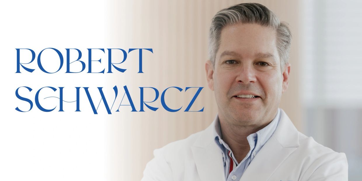 Portrait of Robert Schwarcz in a white coat with his name beside him.