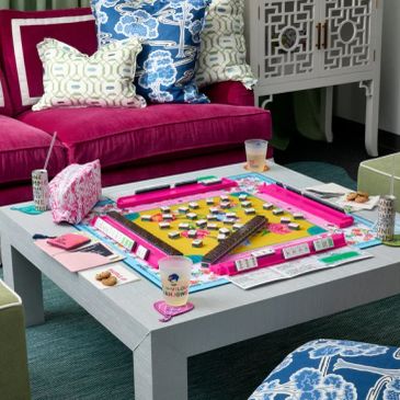 Colorful Mahjong game setup on table in cozy living room.