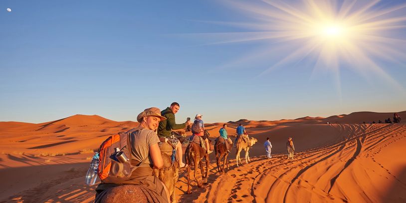 Group of travelers exploring a scenic desert - guided group tour packages and custom adventures