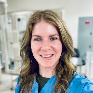 Nurse smiling in an operation room because she no longer has shoulder pain