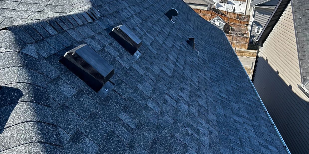 New asphalt shingle roof with vent covers.