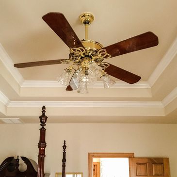 Ceiling fan in a bedroom, representing our fan installation and repair services