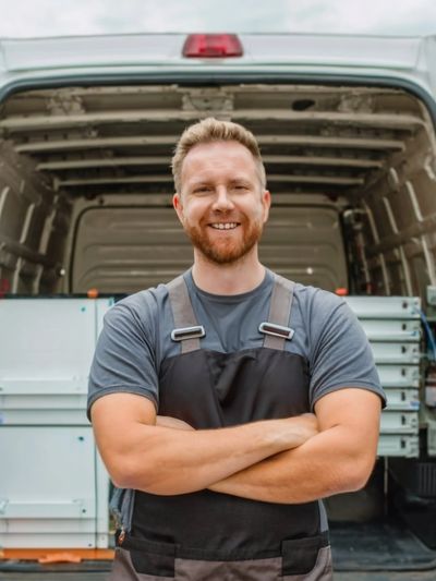 Smiling electrician with arms folded showcasing D-Tyl Electric's human side of hiring an electrician