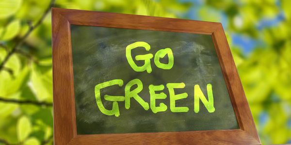 Go Green' chalkboard signifying D-Tyl Electric's eco-friendly focus