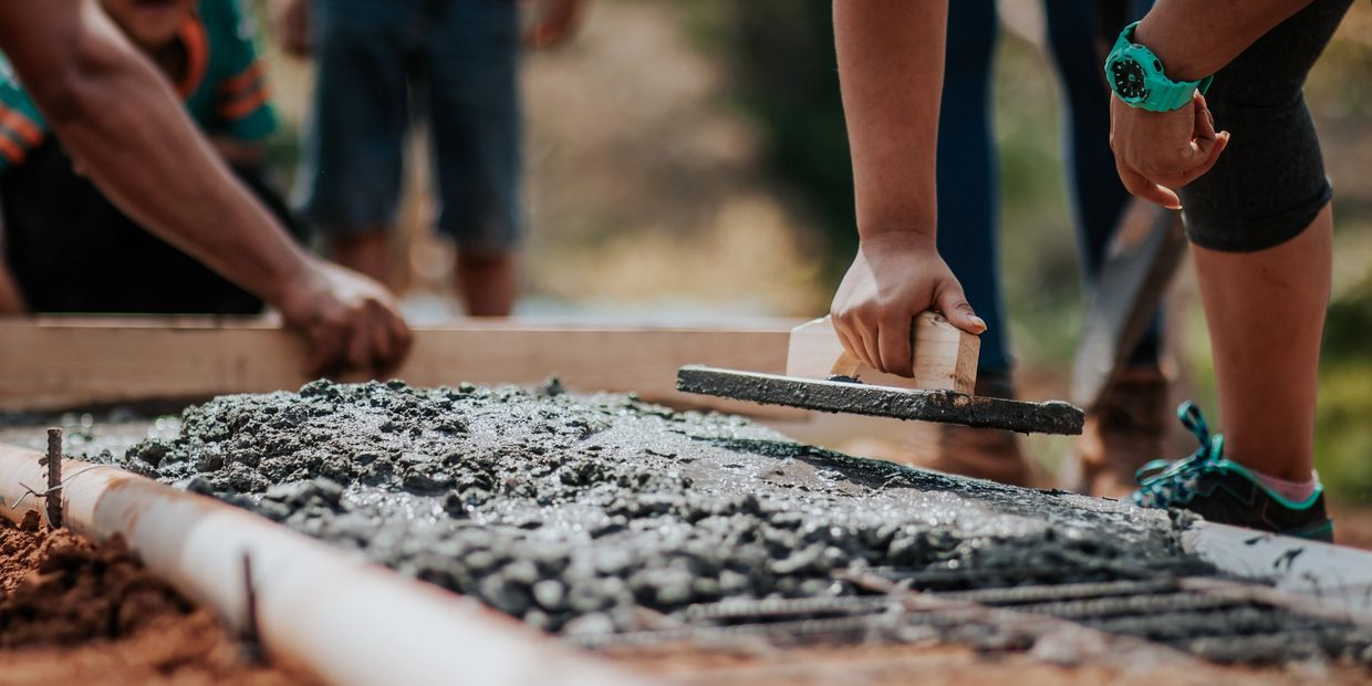 Crafting concrete paths, illustrating infrastructure and progress commitment