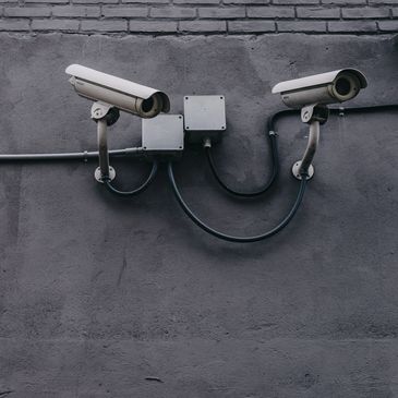 Security cameras mounted on a wall, highlighting our security and safety solutions