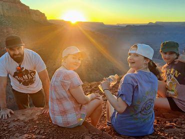Enjoying the sunset at the outcropping Colorado River looking dirty on a Grand Canyon day hike
