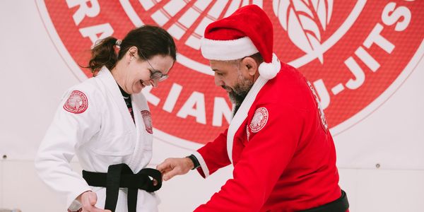 Alex DeSouza awarding Judith Emery her BJJ Black Belt.