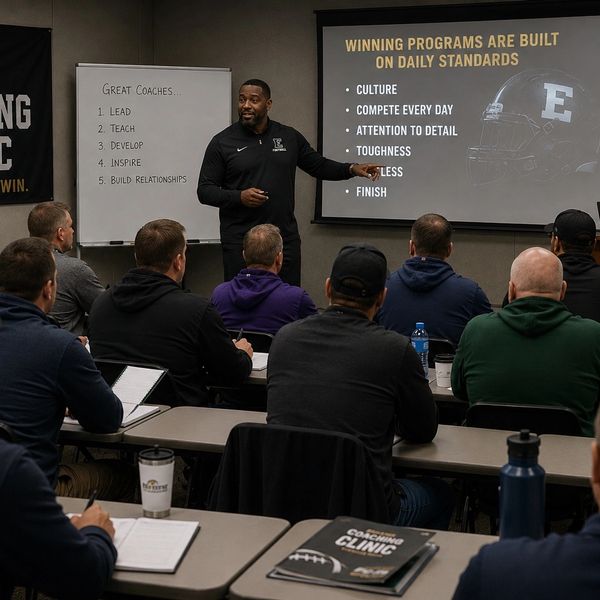 Coach presenting leadership and winning standards to a group.