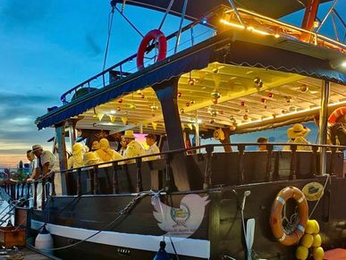 A group of guests on FC wooden deck yacht berthed at Royal Langkawi Yacht Club
