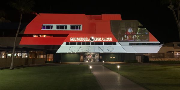 Mindil Beach Casino building illuminated with Christmas-themed lights at night.