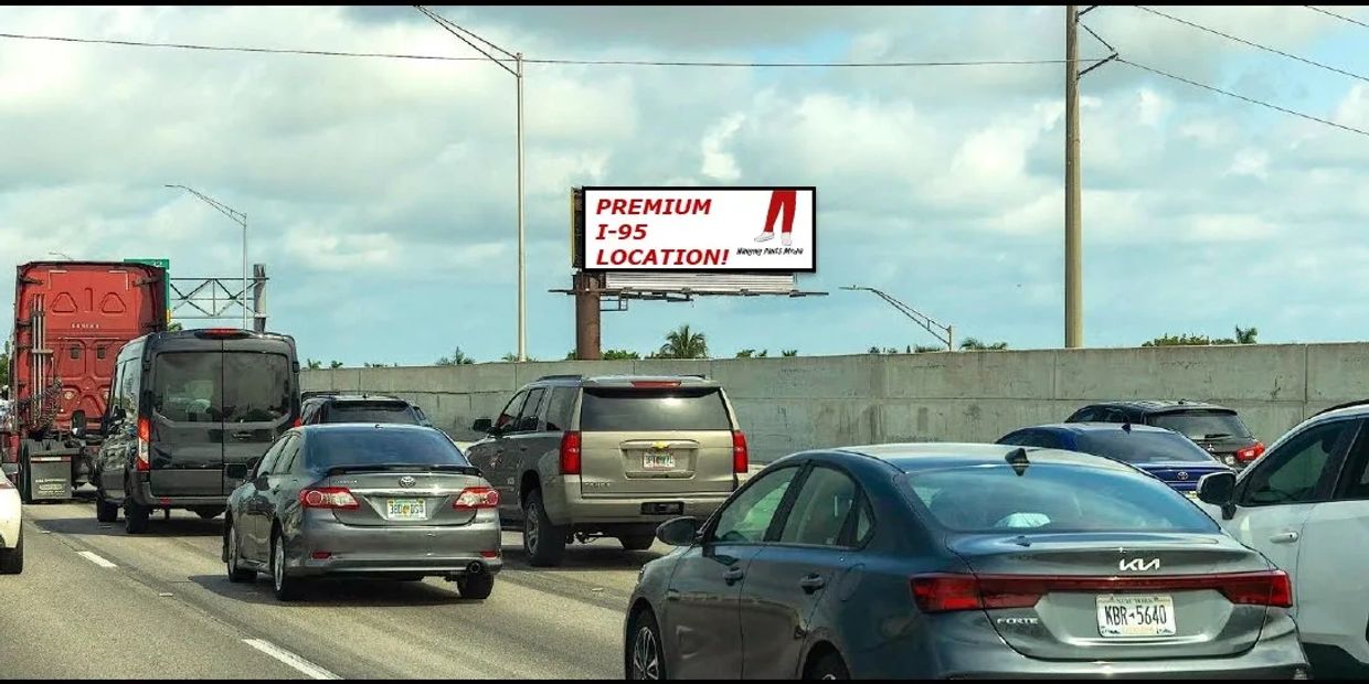 Busy highway with cars and a billboard for premium I-95 location.