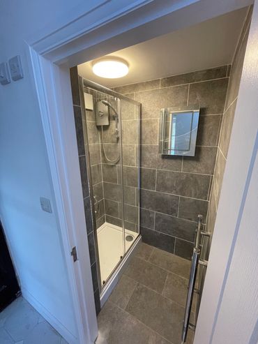A shower room conversion from a utility room on an AirBnB property