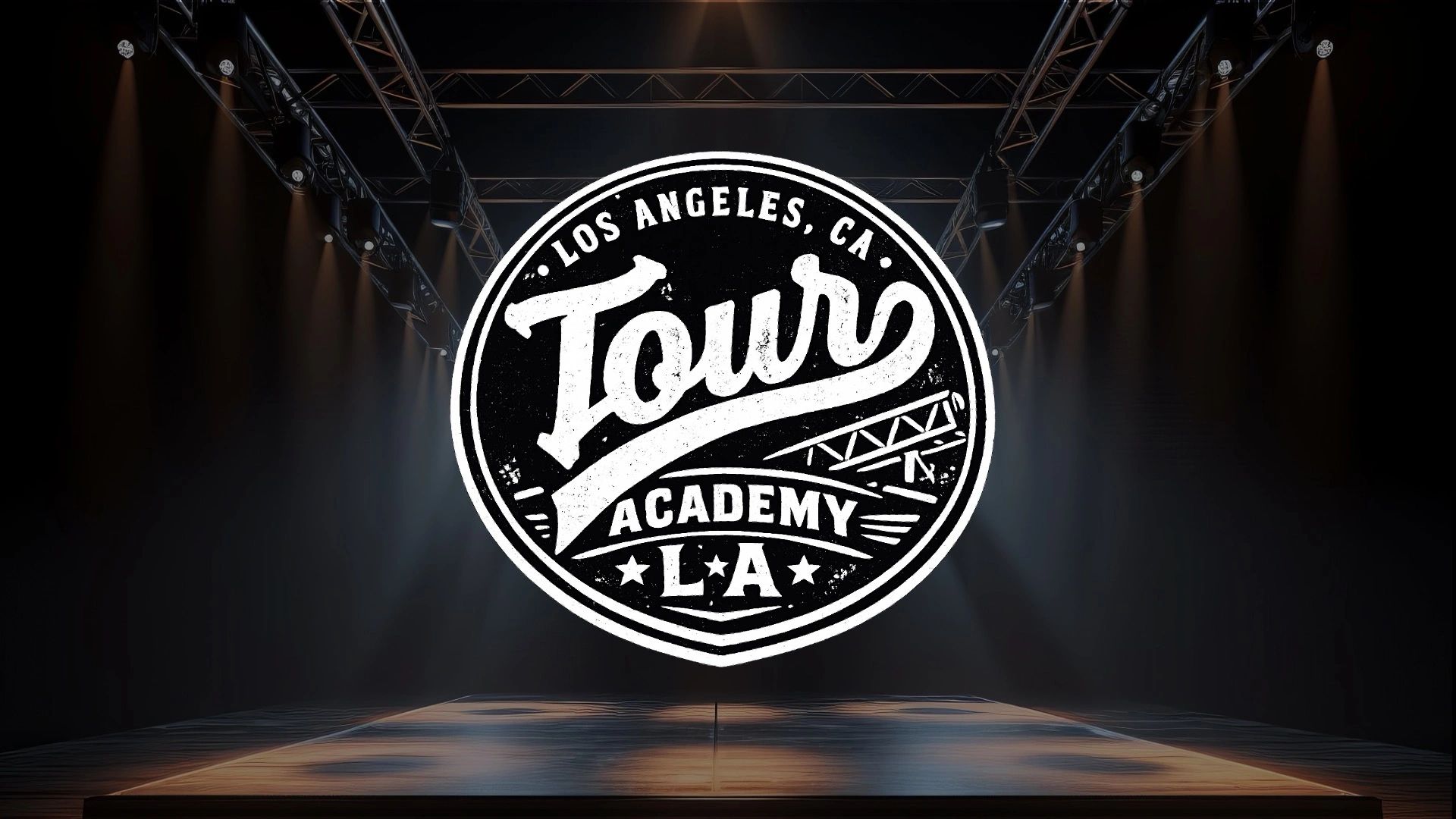 Logo for Tour Academy LA in a spotlight on stage.