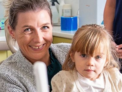 A photo of a happy mum & her 2yo daughter at a dental visit at Jonathan Loughlin Dental.