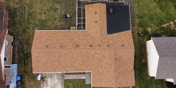 Aerial view of a house with a brown roof.