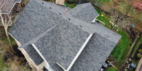 Aerial view of a house roof with gray shingles.