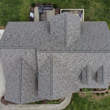 Aerial view of a residential house roof with shingles.