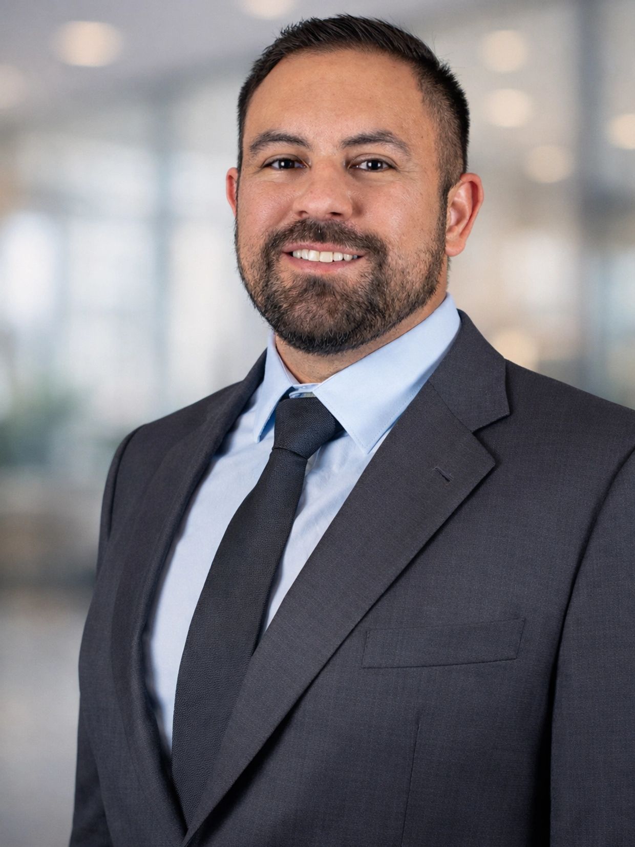 Man in suit smiling confidently.