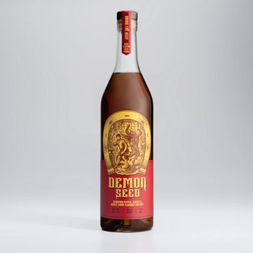 A bottle of Demon Seed whisky on a grey studio backdrop