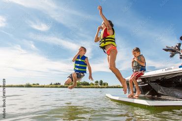 Kids jumping into lake off boat. Folsom Lake Decontamination.